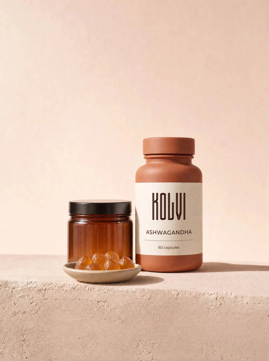 A Kolvi ashwagandha bottle and an amber jar on a clay ledge with a dish of gummies